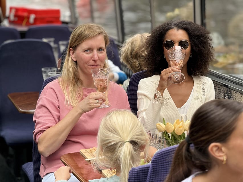 Amsterdam: Luxury Cheese & Wine Canal Cruise - A cheese board with Amsterdam moving past you