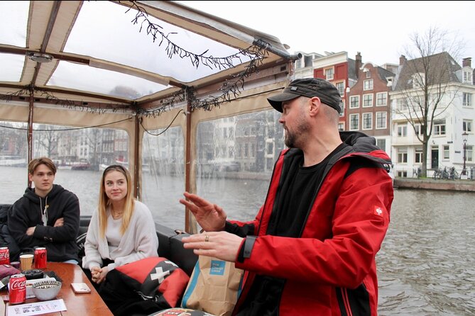 Dutch Cheese & Drinks Guided Amsterdam Boat Tour, All Inclusive - Centraal Station and the green roof of NEMO